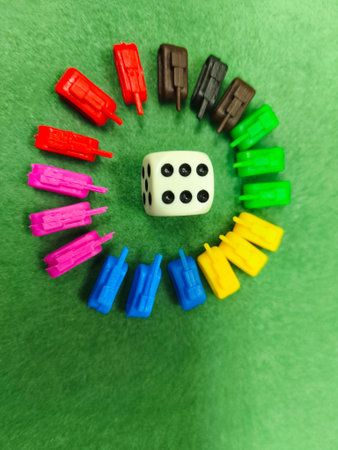 Conceptual image of dominoes and dice on green background