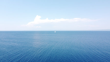 Aerial view of the sea and blue sky with white clouds.
