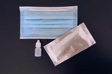 Unopened Coronavirus kit test and surgeon blue mask
