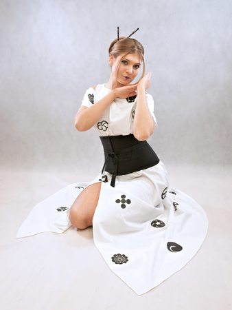 Woman presenting a dress inspired by the Japanese kimonoの写真素材