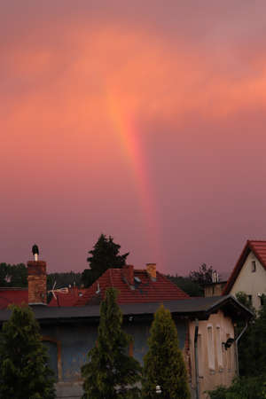 rainbow sign in the sky after a great storm over the cityの写真素材