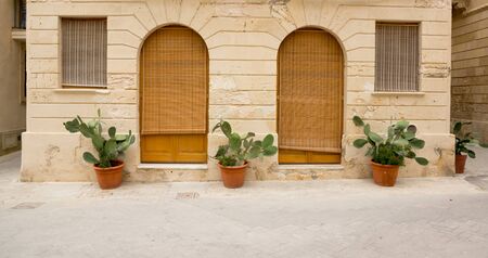 windows and door entrance on the streets of Syracuseの写真素材