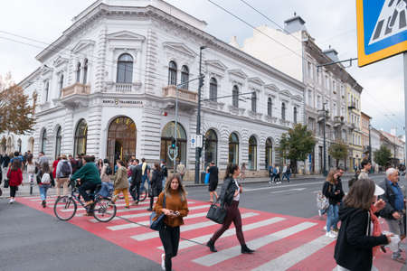 CLUJ-NAPOCA, ROMANIA - OCTOBER2019: People walking on the streets of Cluj-Napoca City Center.