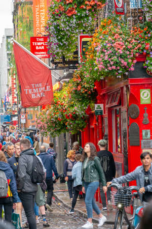 Dublin,Ireland - JULY 30, 2019: People walking by famous Irish pub , THE TEMPLE BARのeditorial素材