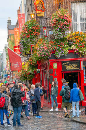 Dublin,Ireland - JULY 30, 2019: People walking by famous Irish pub , THE TEMPLE BARのeditorial素材