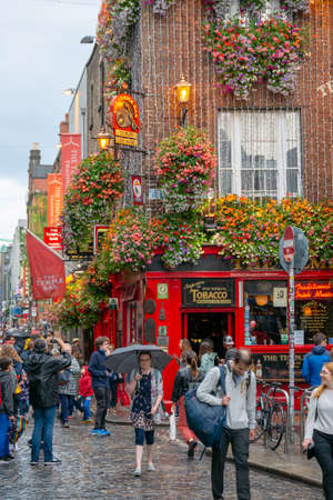 Dublin,Ireland - JULY 30, 2019: People walking by famous Irish pub , THE TEMPLE BARのeditorial素材