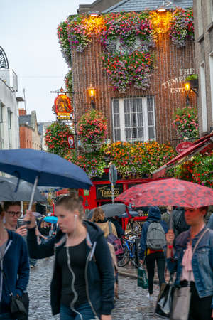 Dublin,Ireland - JULY 30, 2019: People walking by famous Irish pub , THE TEMPLE BARのeditorial素材