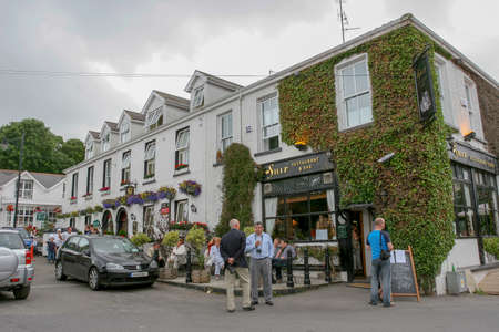 Dunmore East,  Ireland - JULY 09,  2005: People enjoying beautiful day at Dunmore east outside local  Pubのeditorial素材