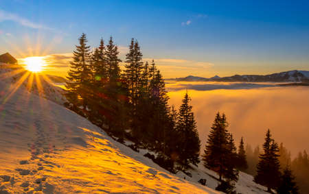 Beautiful sunset over sea of clouds. Winter landscapeの写真素材
