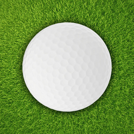 Golf ball on the green grass, isolated on white backgroundの写真素材