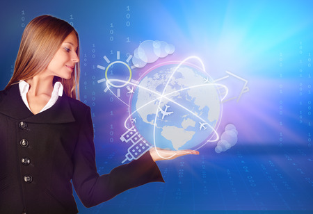 woman showing holding on globe and icon around world mapの写真素材
