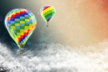 balloons flying outer space above the cloudsの写真素材