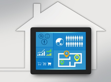 tablet with icons on screen and surrounded the houseの写真素材