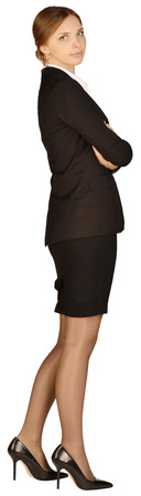 Business woman standing sideways with his arms crossed. white background.の写真素材