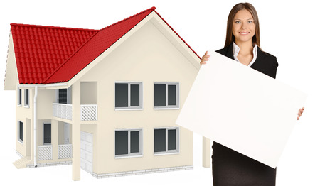 Business woman holding blank poster on background of country house.の写真素材