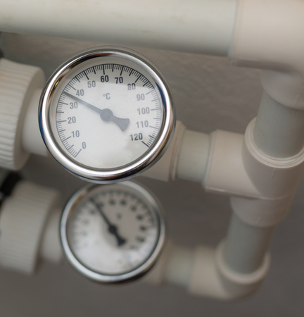 Temperature gauge mounted on the heating pipes.