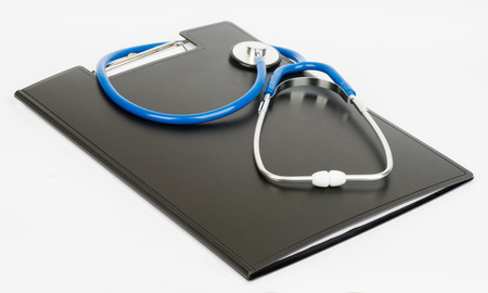 Medical stethoscope and clipboard on a white background.の写真素材