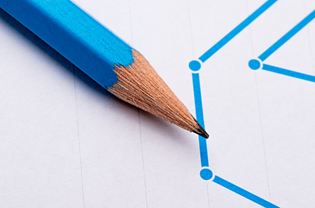 Graphite pencil close-up on a background of graph.の写真素材