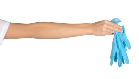 Close-up of female hand holding medical gloves.の写真素材