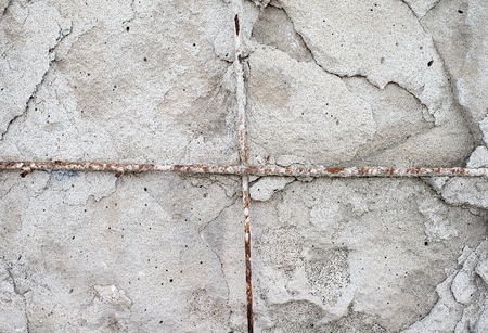 Texture cement wall of destroyed construction with fittings.