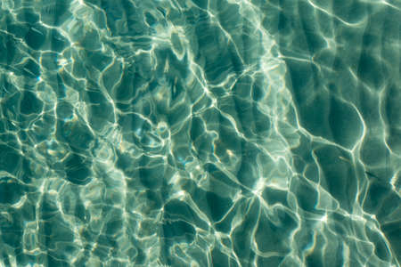Background of the reflection of the sun in the sea water. The pulsation of water.の写真素材