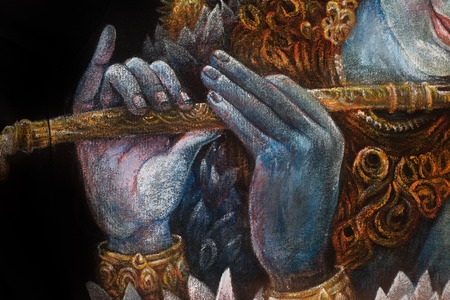 hands of lord krishna playing flute, detail with lotus pattern.の写真素材