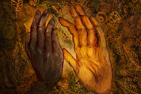two hands from two different worlds comming together in love promise, painting.の写真素材