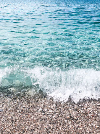 Mediterranean crystal clear water with pebble sand and waves. Nerja beach.の写真素材
