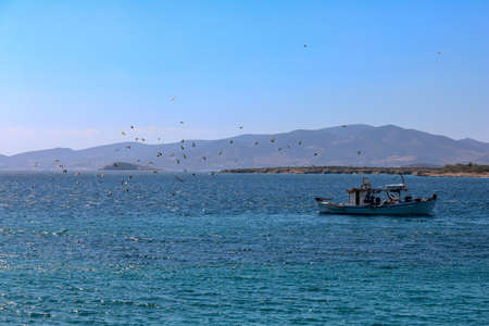 Greek fishing boat sailing on the coast of Paros, Cycladic Islands, Greeceの写真素材