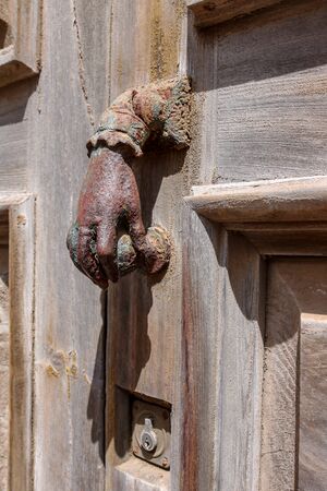 Handshaped Iron Doorknob on a wooden door, Canary Islands, Spainの写真素材