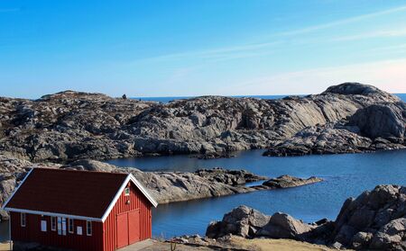 Landscape with red house near Lindesnes, Norway. The coast of southern Norway with an ocean view, rocky sea coast, South Norway, Lindesnes Fyr beacon.の写真素材