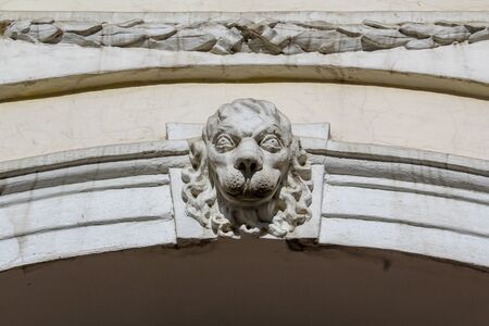 Sculpture of a lion guarding above a gate in Vilnius, Lithuaniaの写真素材