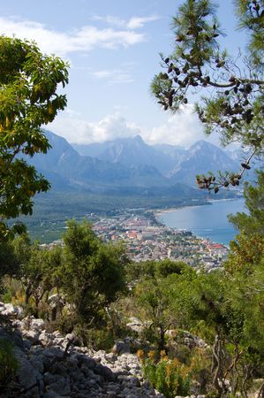Beautiful view of blue sea, beautiful mountains in Turkey through pine-treesの写真素材