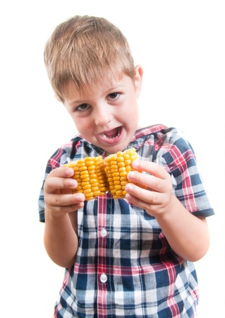 Child eating boiled cornの写真素材