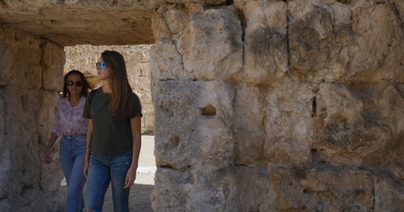 Tourists walking near antique ruins of ancient temple roman architecture in open air museum of Perge, Turkeyの写真素材