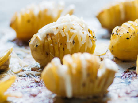 Closeup of baked potato fans before baking on baking paperの写真素材