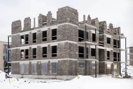 Modern european concrete block apartment building construction in winter time