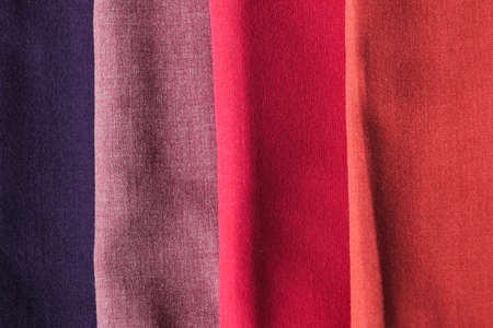 Pile of colorful cotton fabric on white background. Pastel colorful casual hijab scarfs.の写真素材