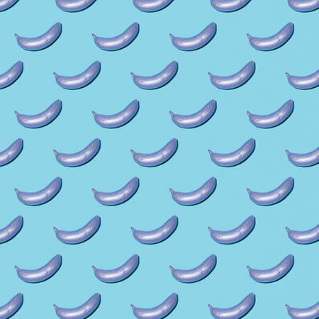 Repeated design features shiny bananas arranged on a playful blue background, enhancing creativity and fun.の写真素材
