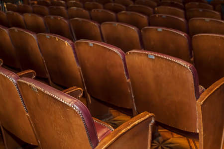 Empty vintage seat in auditorium or theate. Academic gathering, empty old armchairs in a row.の写真素材