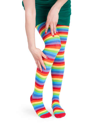 Perfect long female legs in rainbow pantyhoose - isolated on white background - Hot sexy legs in stockingsの写真素材