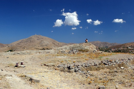 The sitting woman with outlook to the hillの写真素材