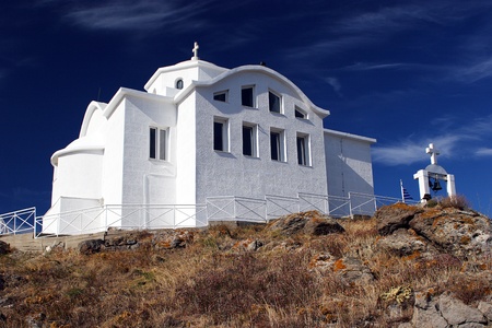 The white greek church with belfry and deep blue skyの写真素材