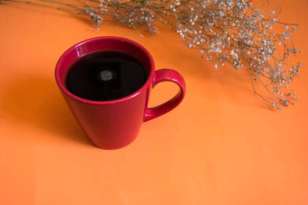 cup of coffee on orange backgroundの写真素材