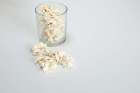 popcorn inside a glass upon a white backgroundの写真素材
