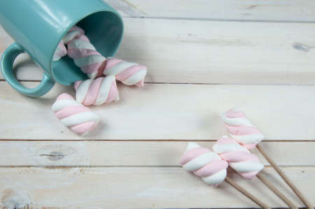 sweet pink marshmallows on a wooden floorの写真素材