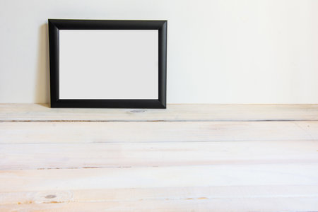 black white frame on wooden background