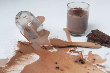 a glass of milk and a cup of chocolate on a white background