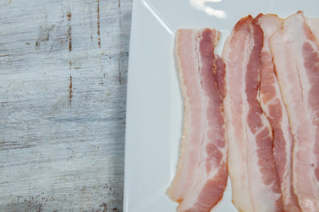 Delicious bacon on top of a white backgroundの写真素材