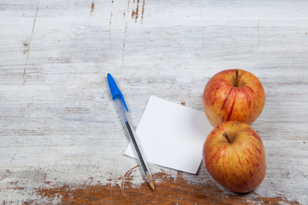 Blank sheet with a blue pen and apple on the side